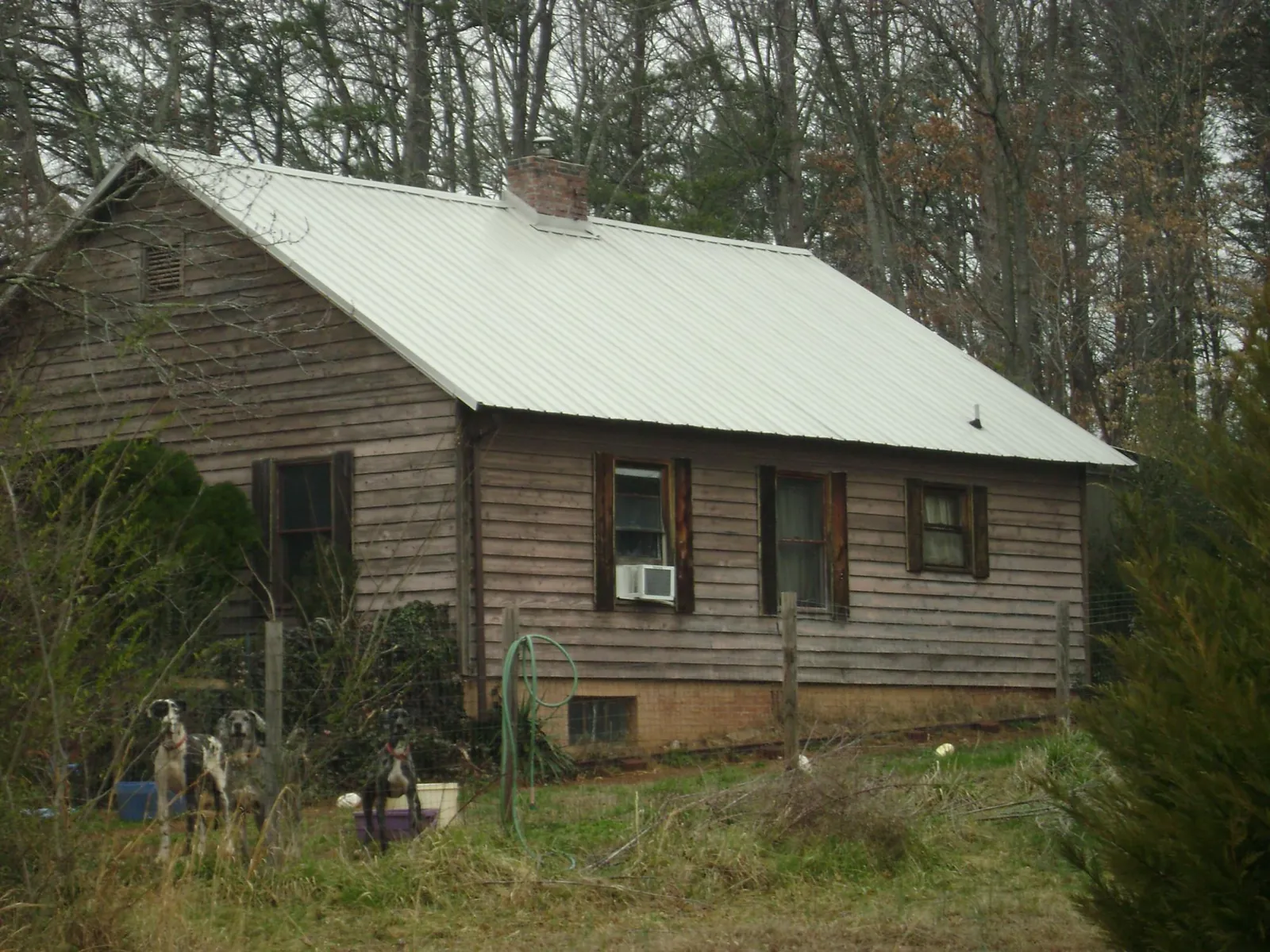White metal roof on an old wood sided farmhouse, from a Metal Roof Installation job in Kulpmont